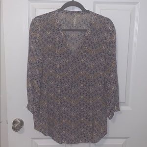 Blue, tan, white patterned blouse